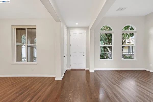 a kitchen with a sink a counter top space stainless steel appliances and cabinets