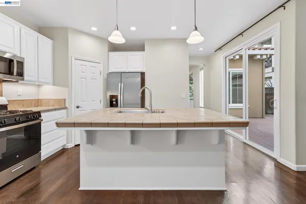 an empty room with wooden floor and a window