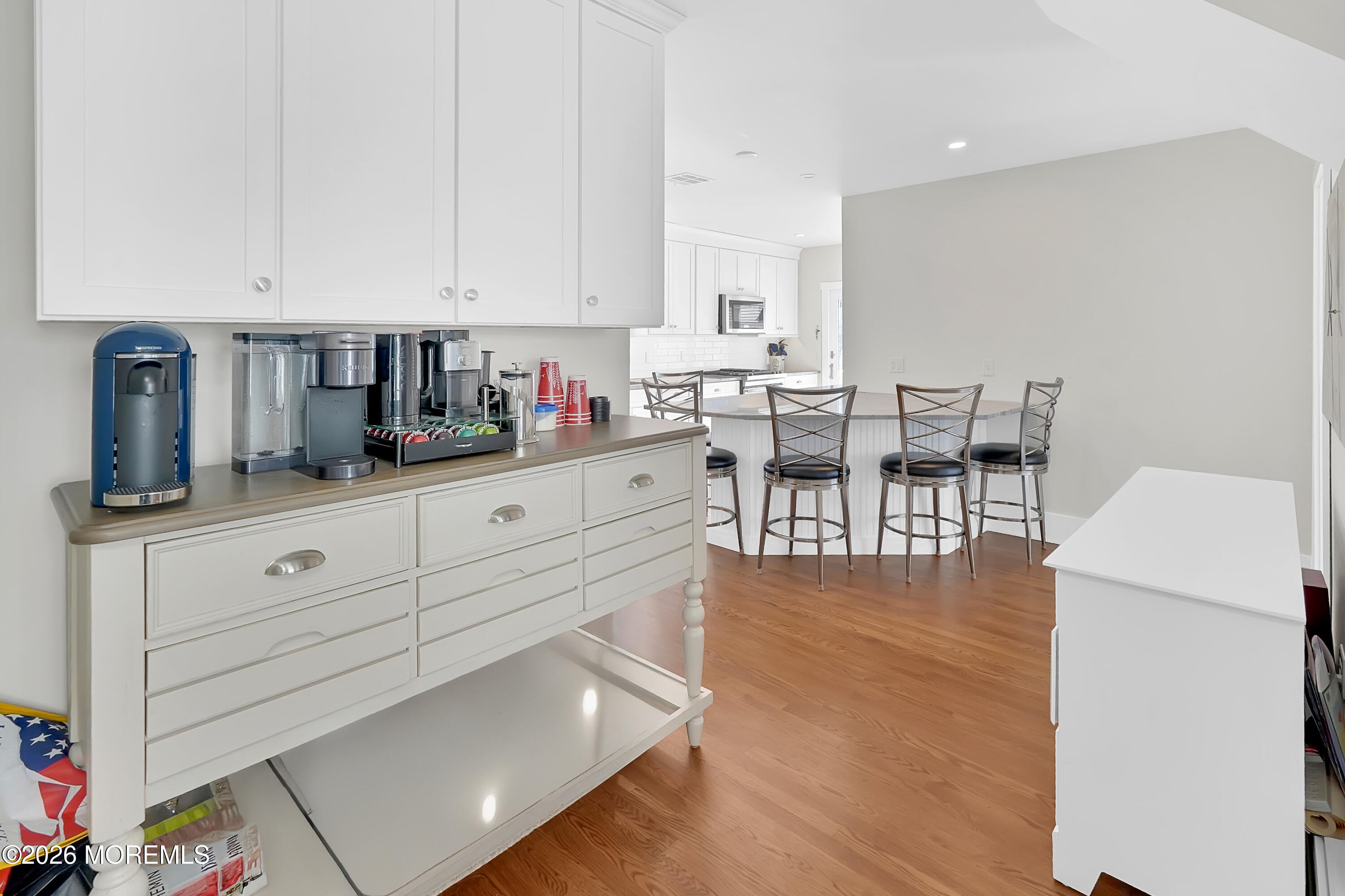 112 Euclid Avenue Allenhurst, NJ 07711 - Photo 39 of 52 a kitchen with white cabinets and wooden floor