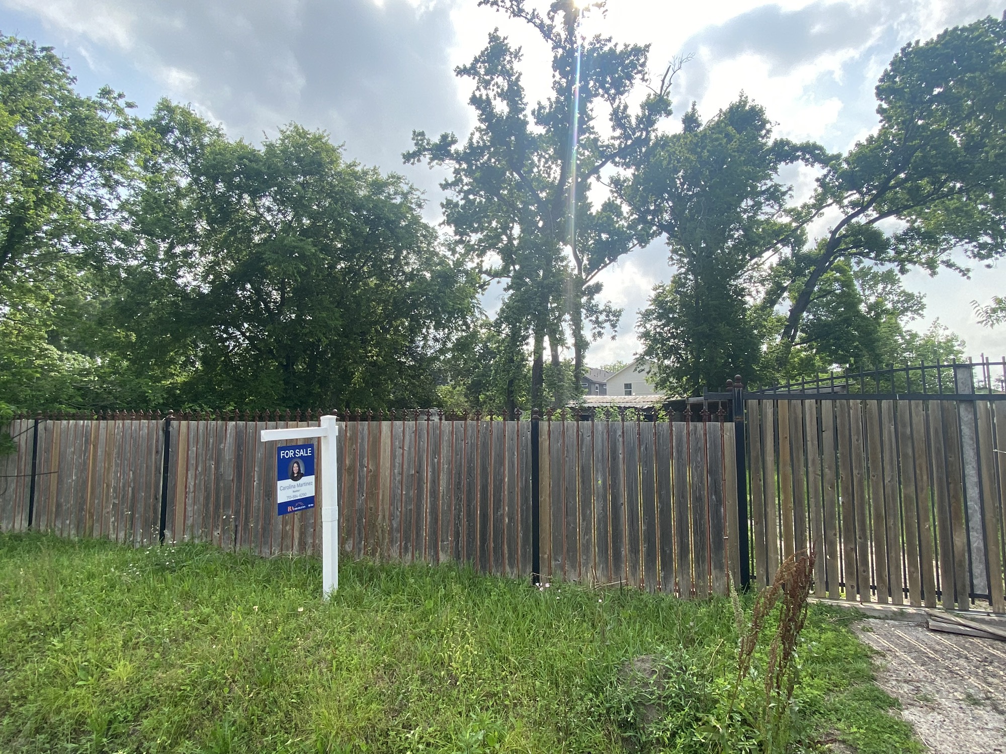 9417 Pembrook Street Houston, TX 77016 - Photo 1 of 4 a view of a backyard with a trees and wooden fence