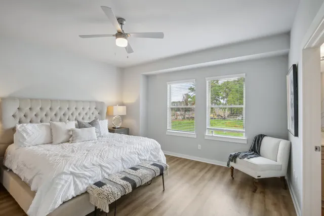 a bedroom with a bed and a large window