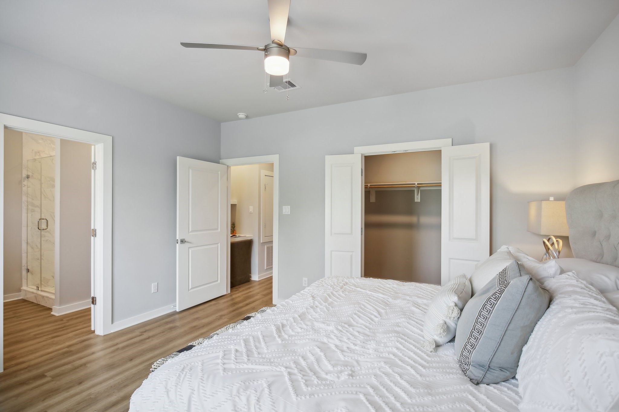5779 Spring Stuebner Road Spring, TX 77388 - Photo 5 of 12 a bedroom with a bed and a chandelier