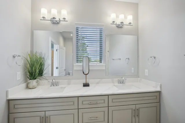a bathroom with a sink double vanity and a mirror
