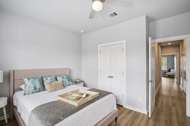 a bedroom with a bed and a chandelier