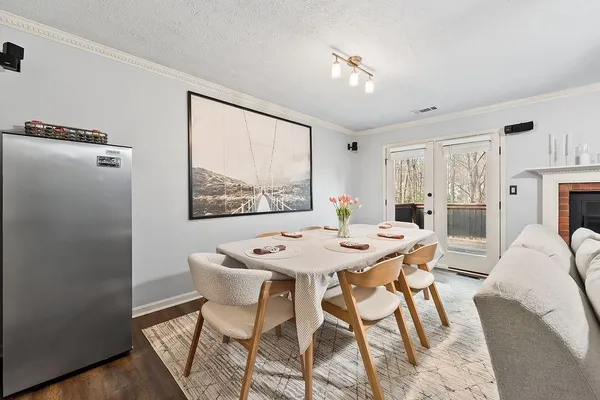 a view of a dining room with furniture and a chandelier