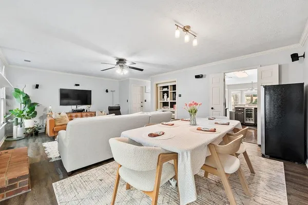 a view of a dining room with furniture and a flat screen tv