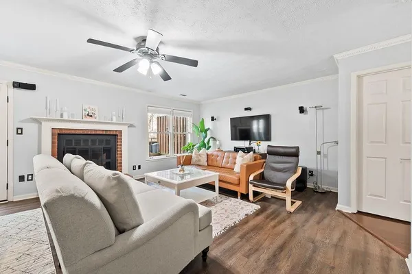 a living room with furniture fireplace and flat screen tv