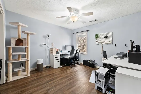 a view of a workspace with furniture and a window