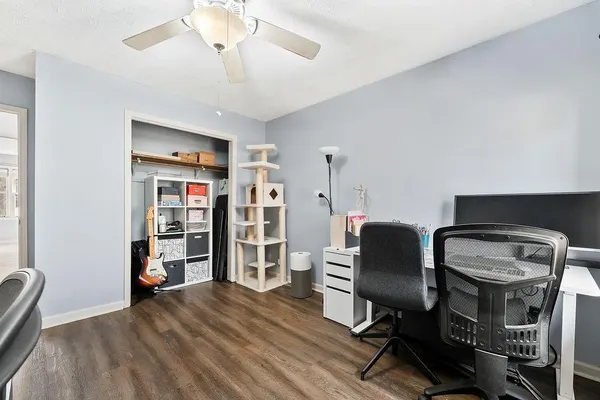 a view of a workspace with furniture and wooden floor