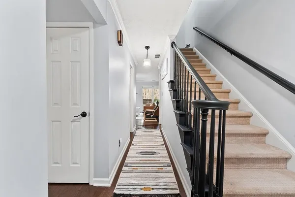 a view of a hallway with wooden floor and entryway