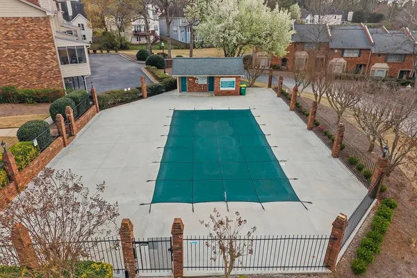 a view of a entrance gate of the house and trees