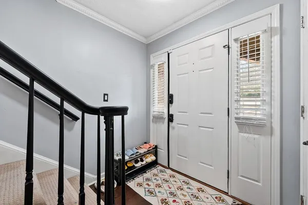 a view of entryway with wooden floor and furniture