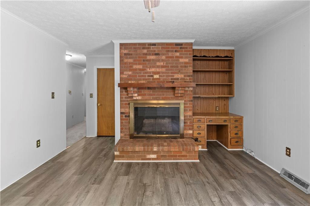 137 Roxdale Place Roxboro, NC 27574 - Photo 18 of 30 a living room with a fireplace and a wooden floor