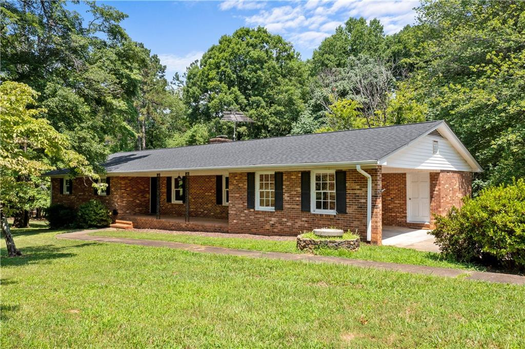 137 Roxdale Place Roxboro, NC 27574 - Photo 2 of 30 a front view of a house with a yard and trees
