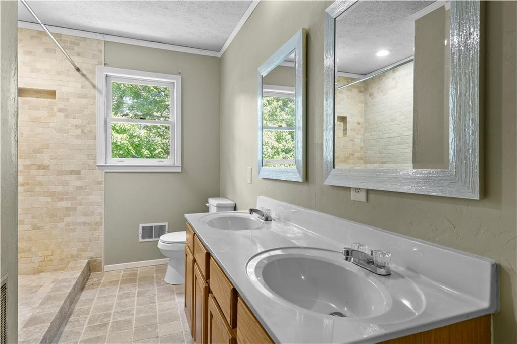 137 Roxdale Place Roxboro, NC 27574 - Photo 23 of 30 a bathroom with a sink and a mirror