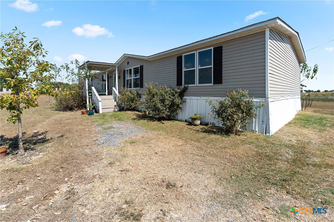 14815 Johnson Rd Trail Manor, TX 78653 - Photo 17 of 37 a view of a house with a yard and potted plants
