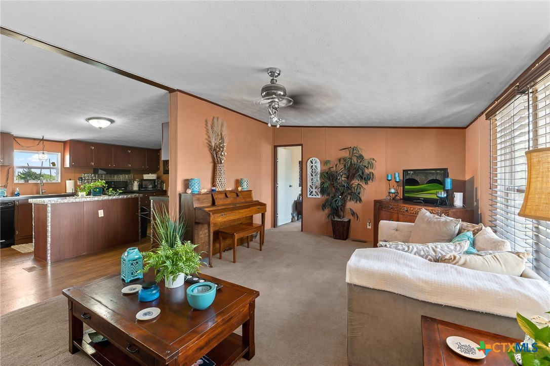 14815 Johnson Rd Trail Manor, TX 78653 - Photo 19 of 37 a living room with furniture kitchen view and a large window