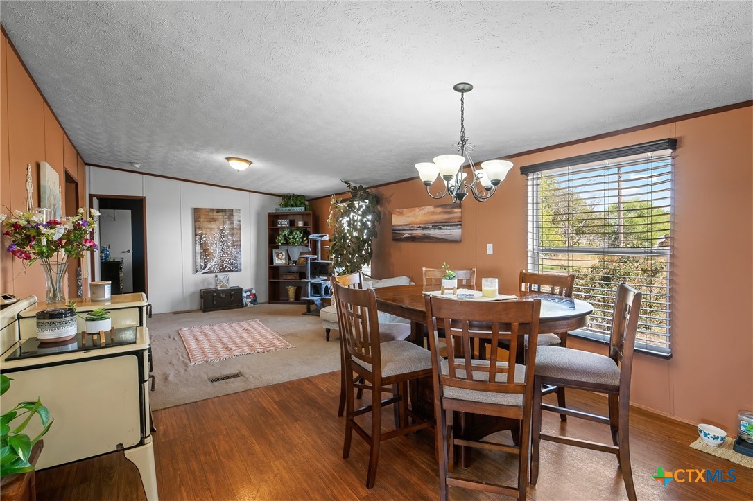 14815 Johnson Rd Trail Manor, TX 78653 - Photo 24 of 37 a view of a dining room with furniture window and wooden floor