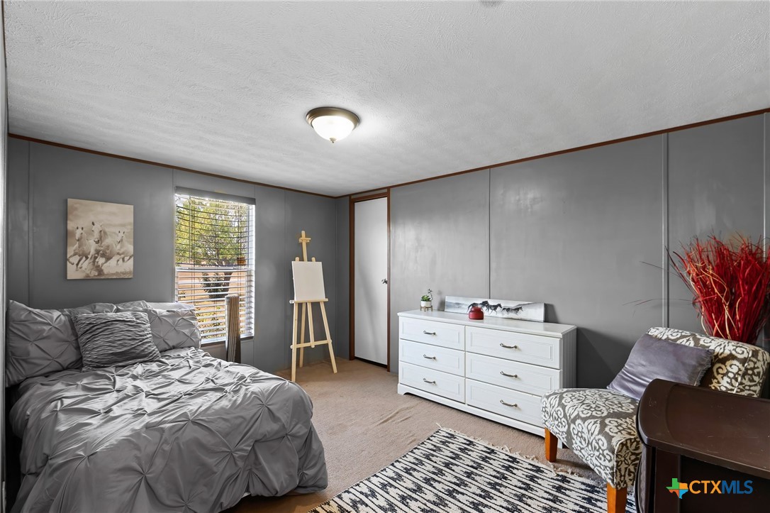 14815 Johnson Rd Trail Manor, TX 78653 - Photo 28 of 37 a bedroom with a bed and furniture