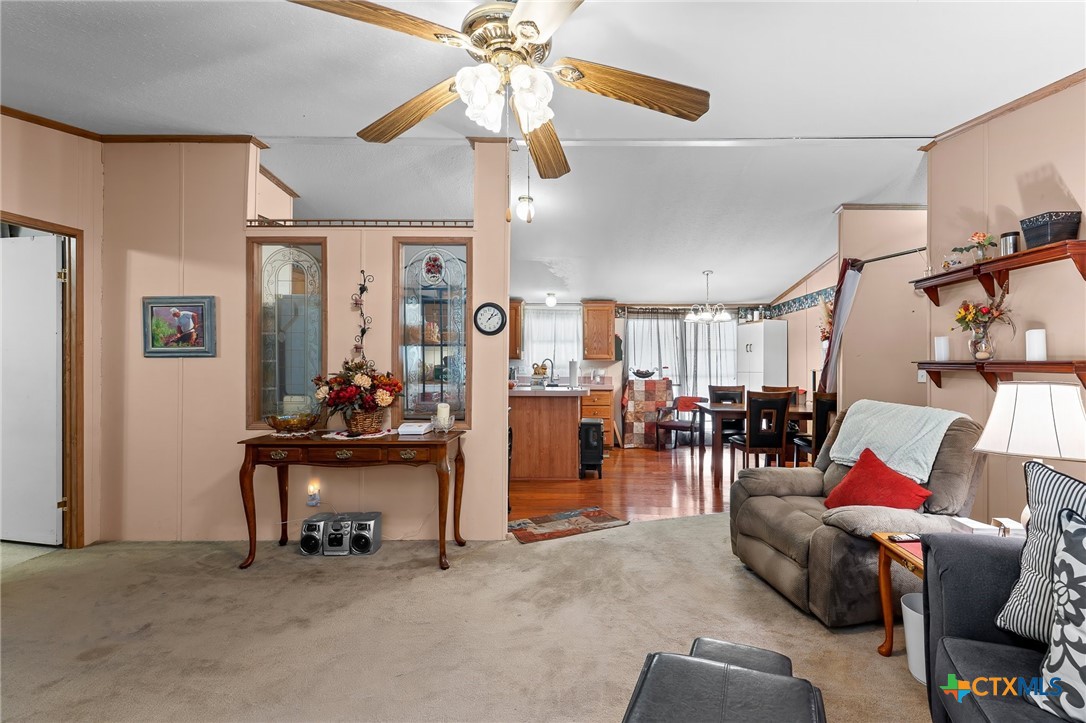 14815 Johnson Rd Trail Manor, TX 78653 - Photo 6 of 37 a living room with furniture and a chandelier