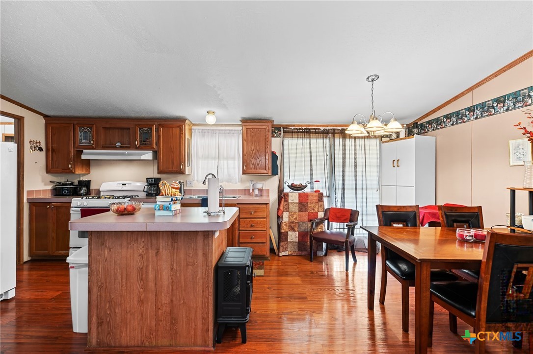 14815 Johnson Rd Trail Manor, TX 78653 - Photo 7 of 37 a kitchen with stainless steel appliances granite countertop a stove and cabinets