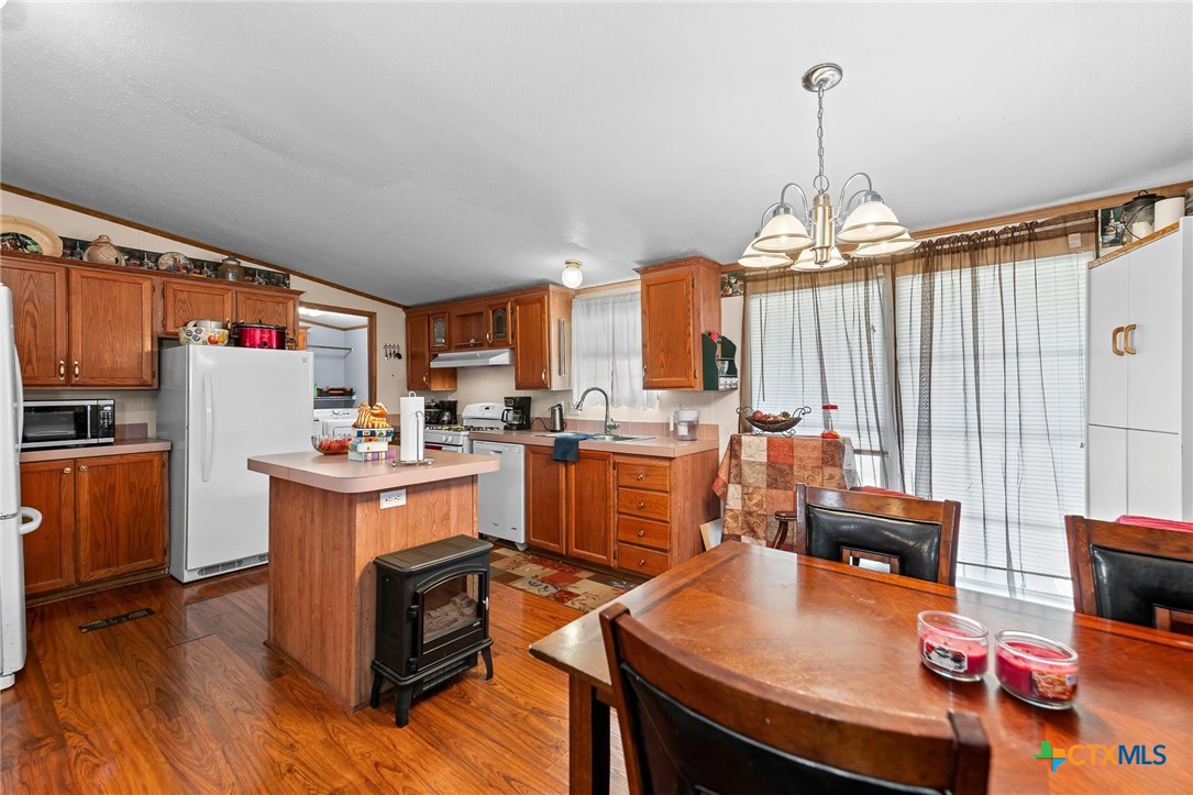 14815 Johnson Rd Trail Manor, TX 78653 - Photo 8 of 37 a open kitchen with stainless steel appliances granite countertop a stove kitchen island a refrigerator and a stove