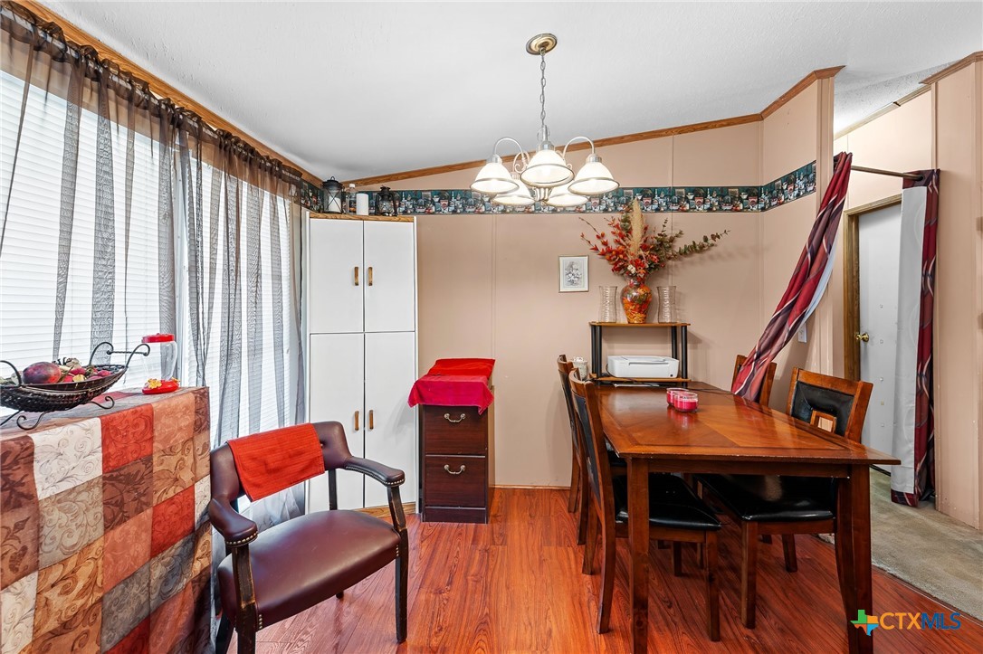 14815 Johnson Rd Trail Manor, TX 78653 - Photo 9 of 37 a view of a dining room with furniture and chandelier