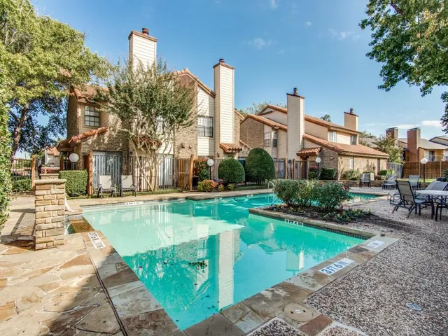 a view of a house with swimming pool and sitting area