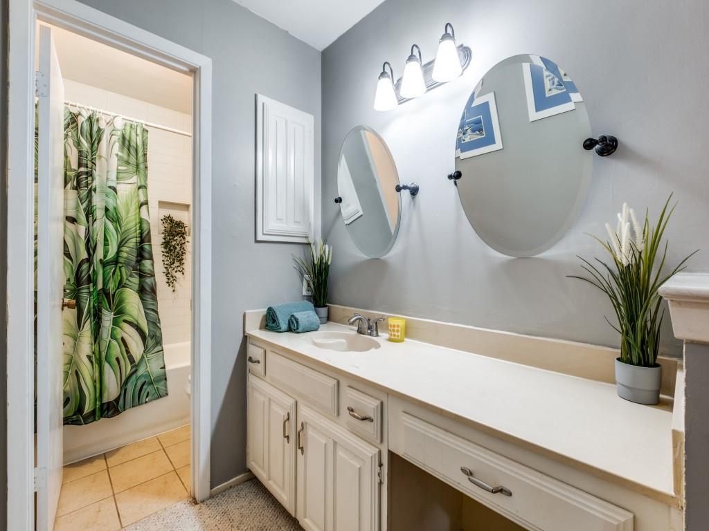 5626 Preston Oaks Road, Unit 46C Dallas, TX 75254 - Photo 16 of 25 a bathroom with a sink a mirror and a potted plant