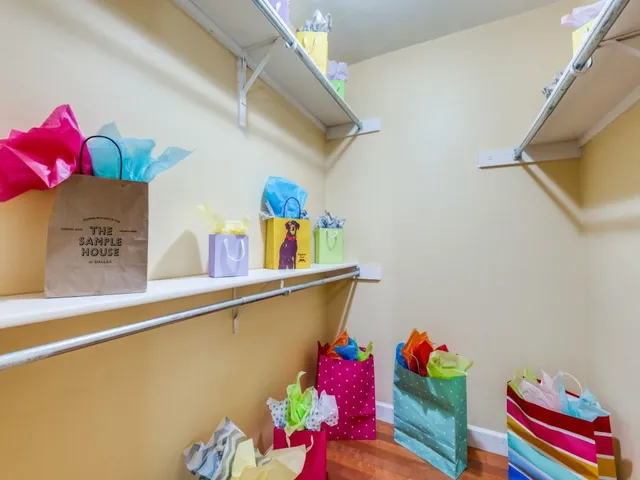 a bathroom with a sink a mirror and a potted plant