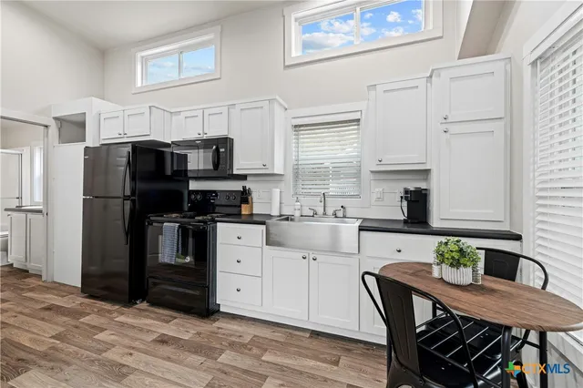 a kitchen with stainless steel appliances a refrigerator stove microwave and cabinets