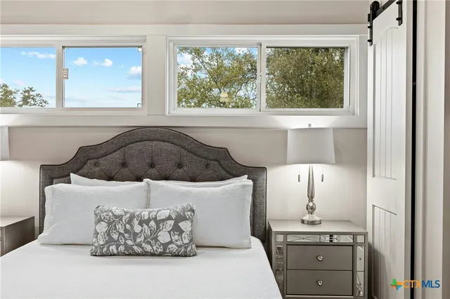 a bed room with a bed and a window