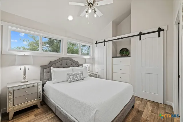 a bedroom with a bed and a painting on the wall