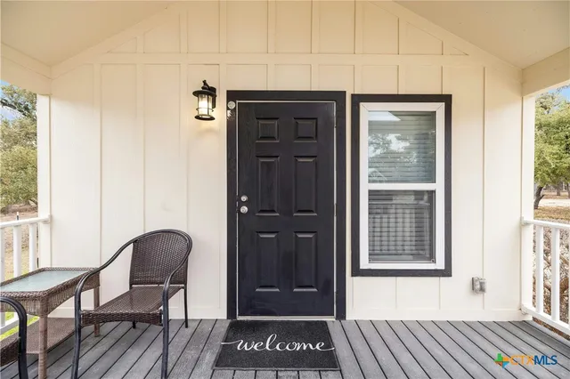 a view of a hallway with wooden floor and windows