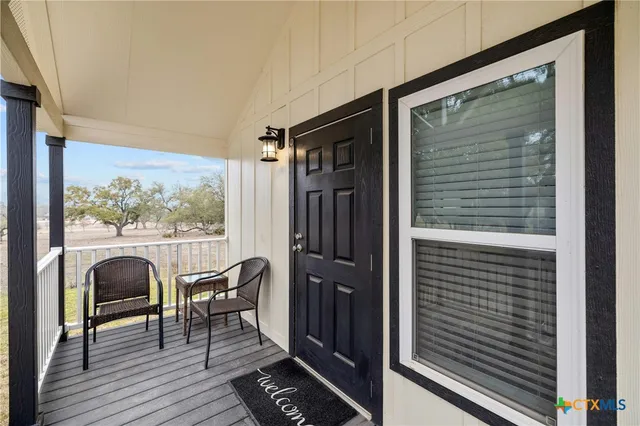 a view of a balcony door and furniture