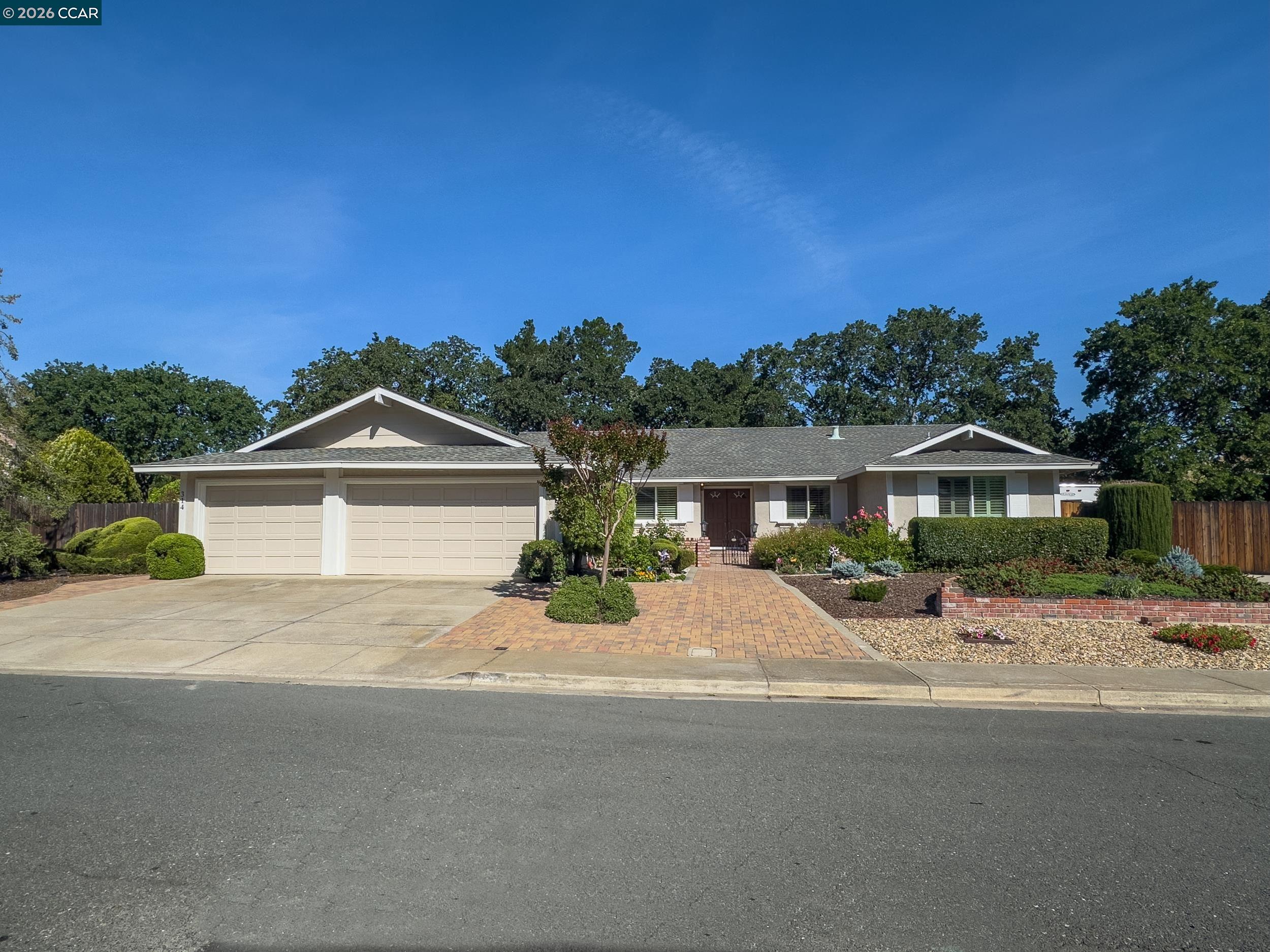 314 Semillon Circle Clayton, CA 94517 - Photo 1 of 38 a front view of a house with a yard and garage