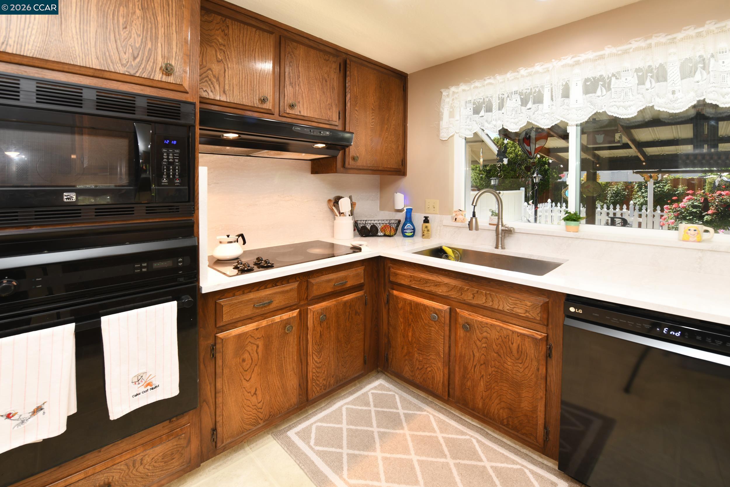 314 Semillon Circle Clayton, CA 94517 - Photo 11 of 38 a kitchen with a sink and a stove