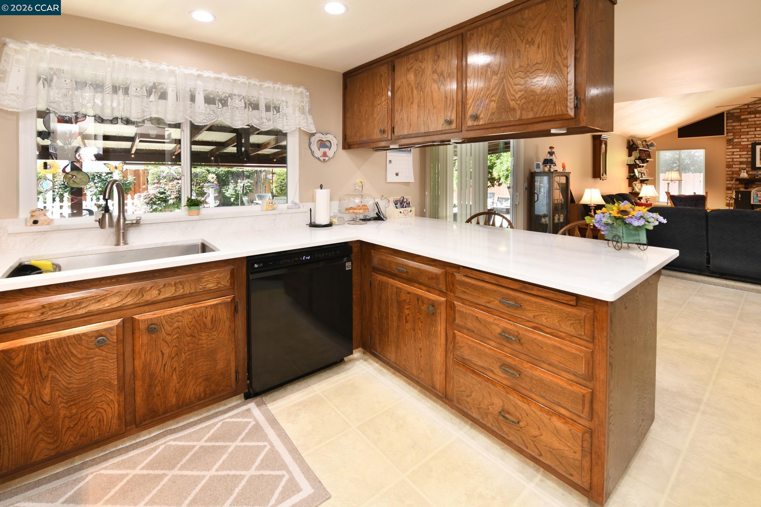 314 Semillon Circle Clayton, CA 94517 - Photo 12 of 38 a kitchen with stainless steel appliances granite countertop a sink and cabinets