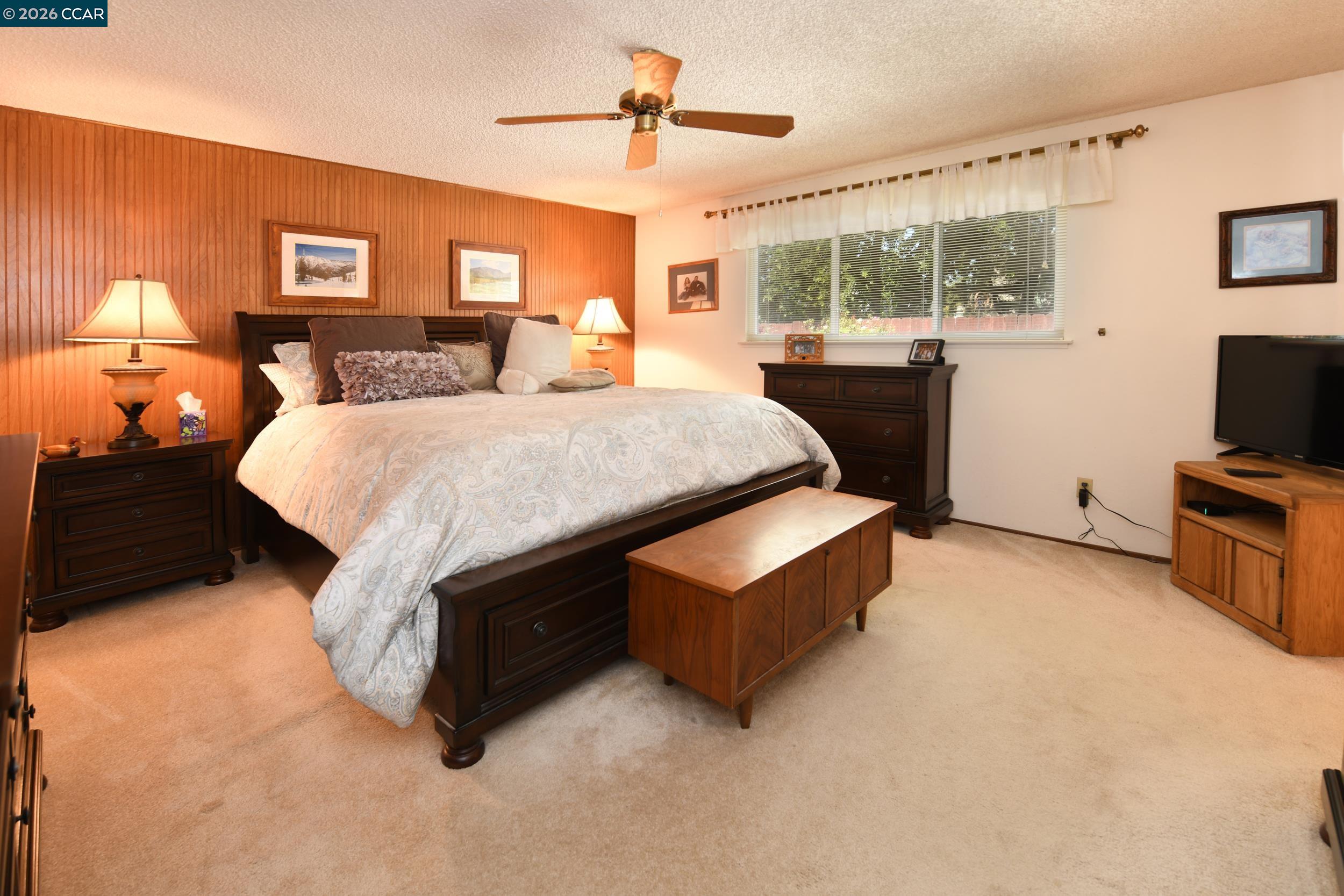 314 Semillon Circle Clayton, CA 94517 - Photo 20 of 38 a bed room with a bed window and a flat screen tv
