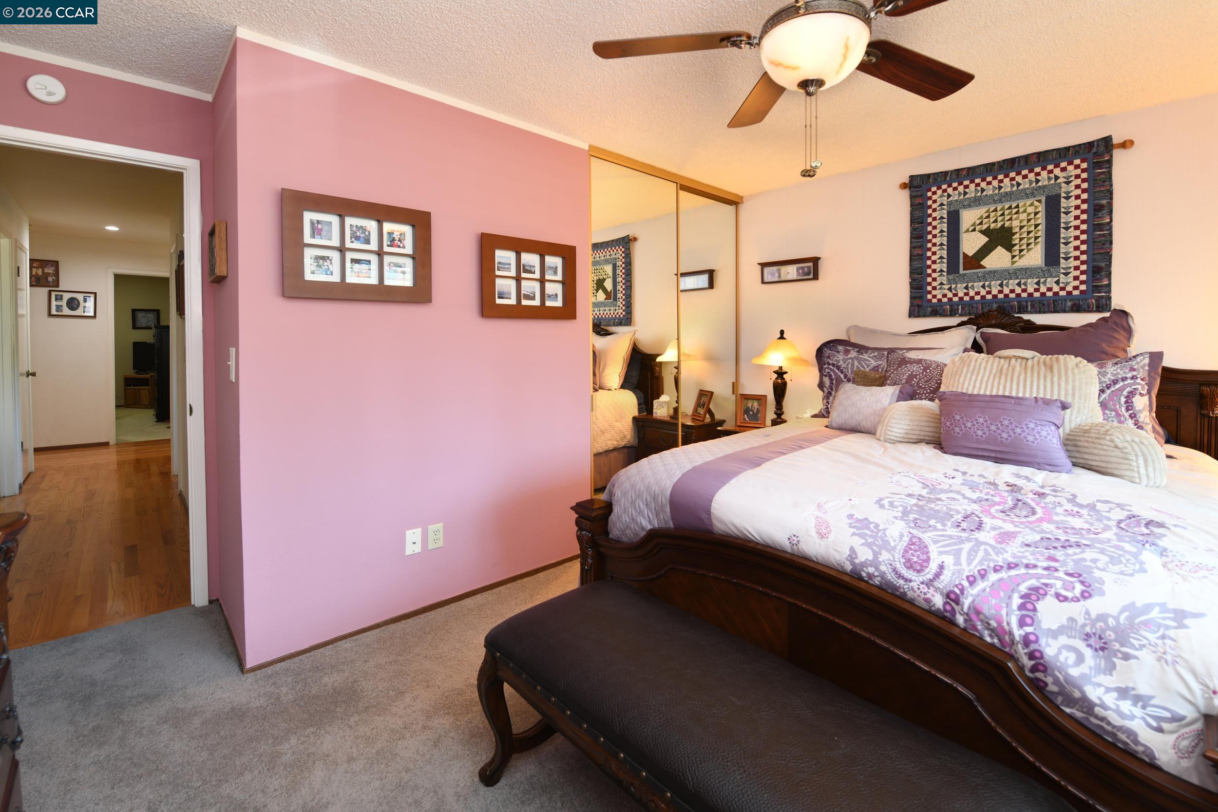 314 Semillon Circle Clayton, CA 94517 - Photo 24 of 38 a bedroom with a bed and a chandelier