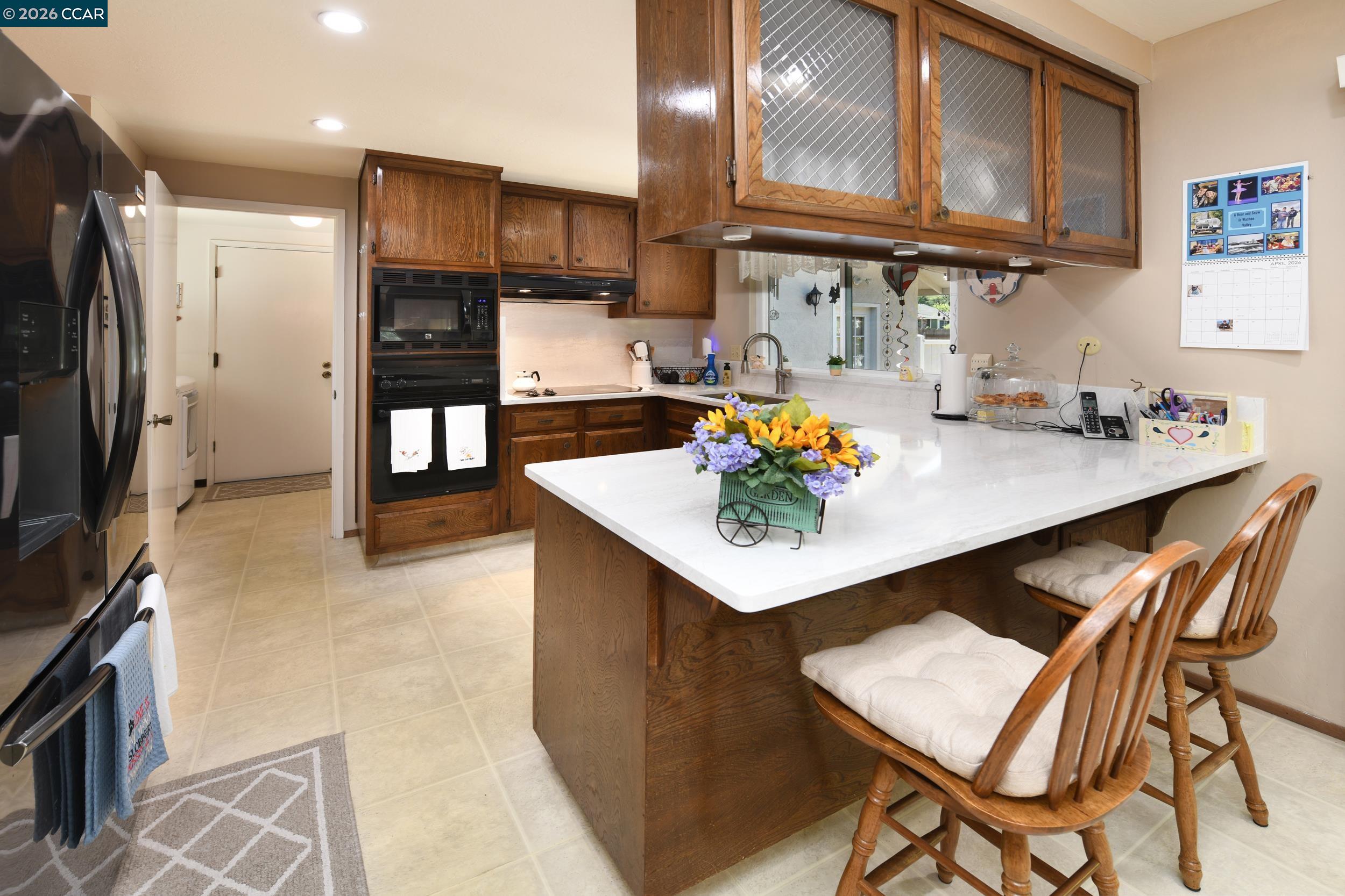 314 Semillon Circle Clayton, CA 94517 - Photo 8 of 38 a kitchen with stainless steel appliances a sink a stove a refrigerator and cabinets