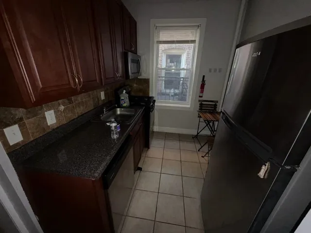 a kitchen with a sink a refrigerator and a stove