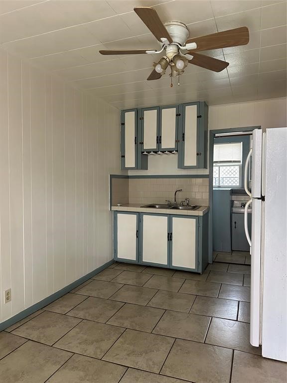 708 J, Unit REAR Galveston, TX 77550 - Photo 2 of 6 a view of a kitchen with a sink and dishwasher a refrigerator with white cabinets
