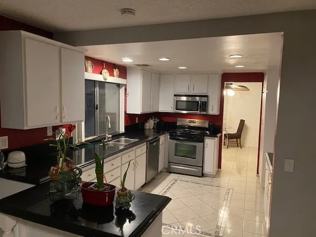 a kitchen with a sink appliances and cabinets