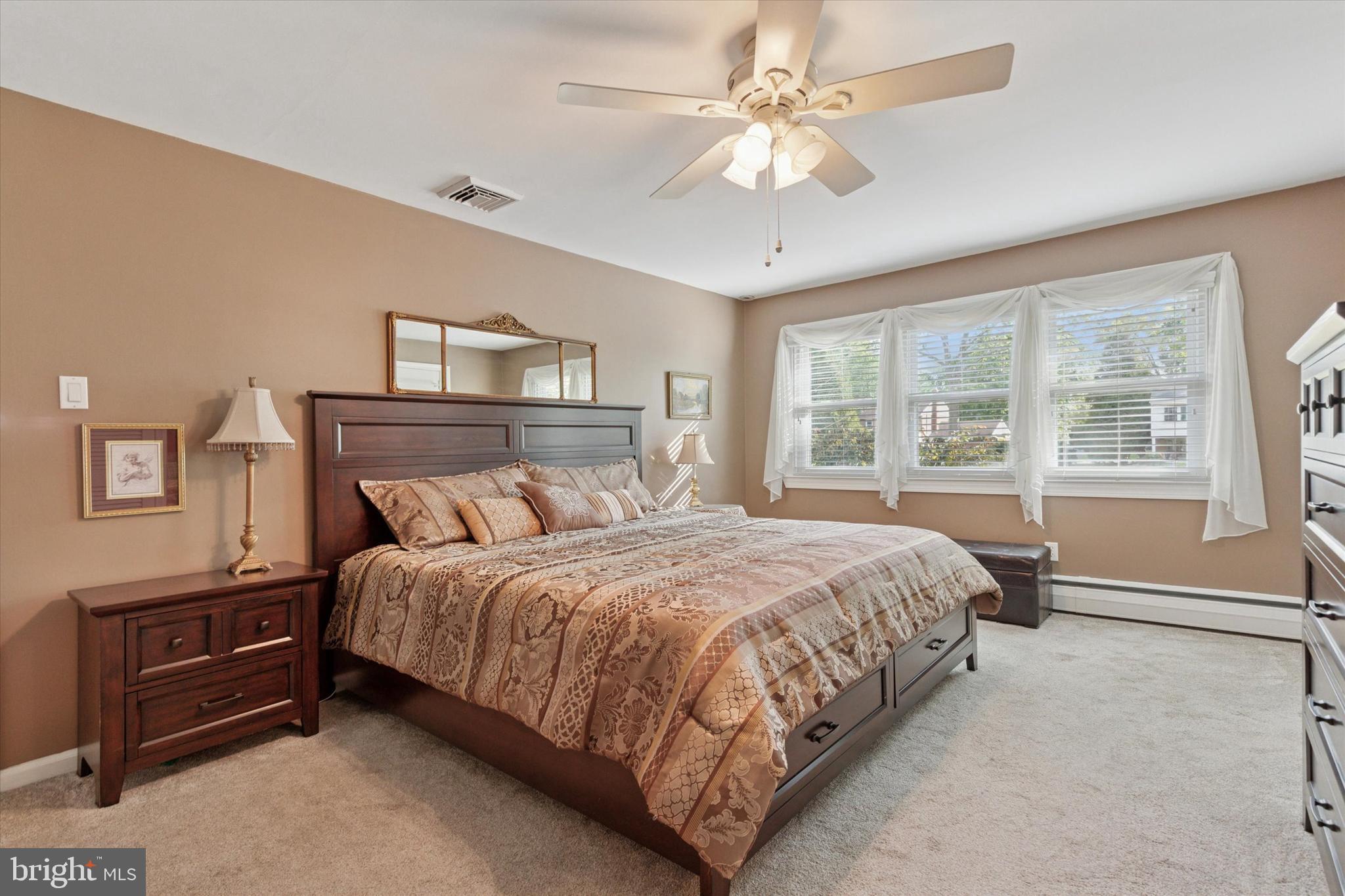 1992 Keswick Way Eagleville, PA 19403 - Photo 11 of 26 a bedroom with a bed chandelier and a window