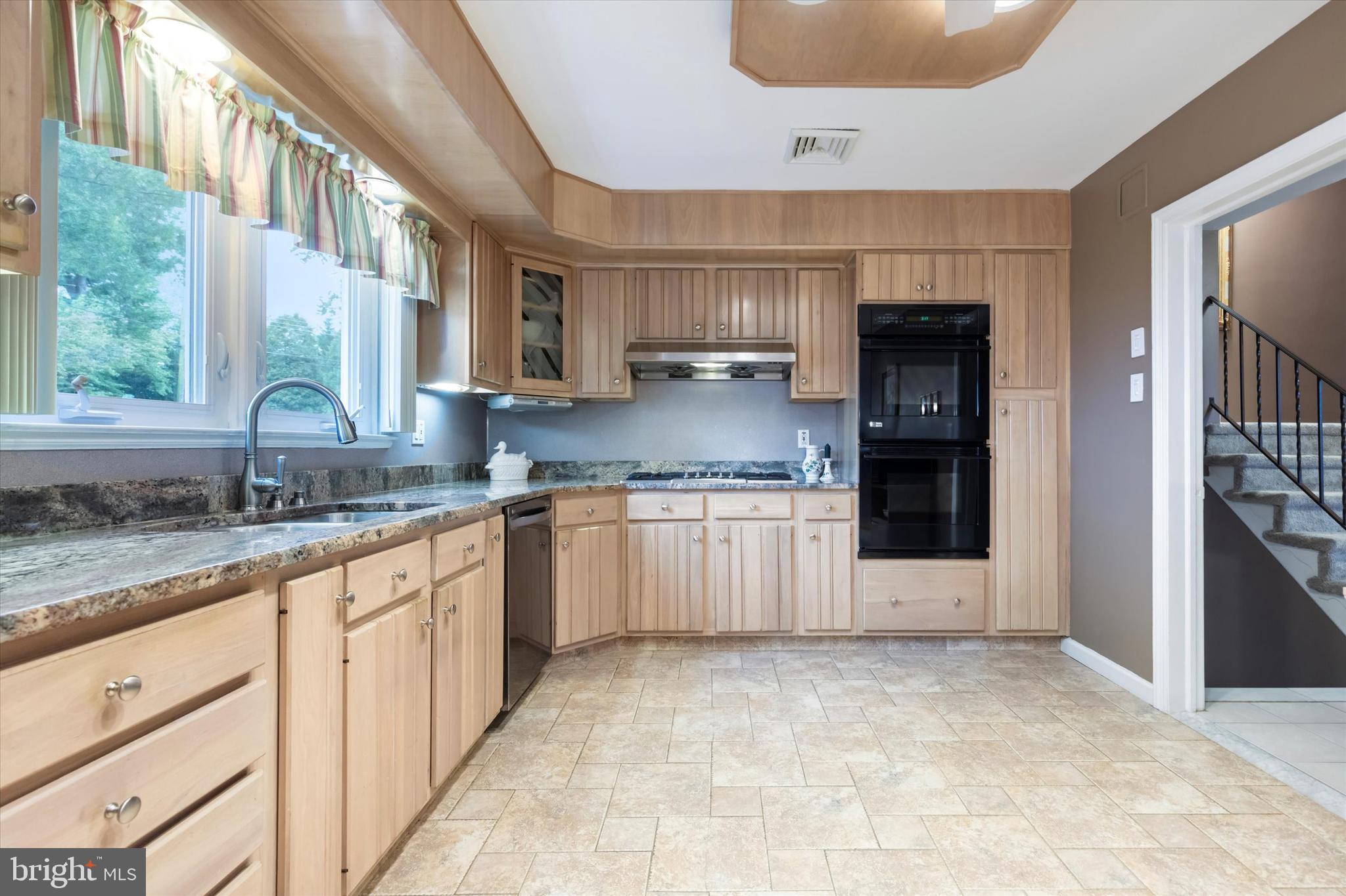1992 Keswick Way Eagleville, PA 19403 - Photo 7 of 26 a large kitchen with granite countertop a sink and cabinets