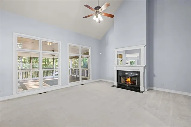a view of a livingroom with a fireplace and a window
