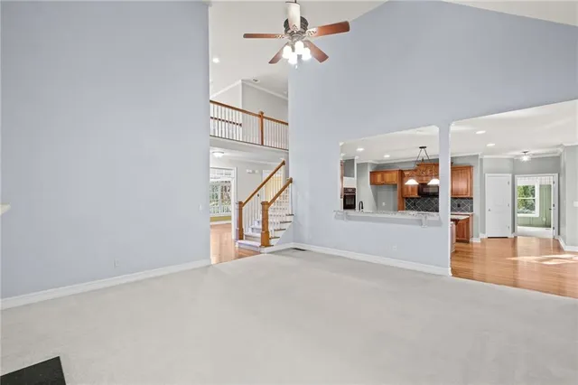a view of an empty room with a kitchen