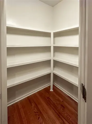 a view of walk in closet with empty racks