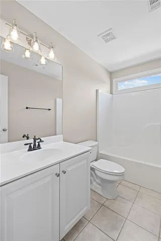a bathroom with a sink a toilet a mirror and vanity